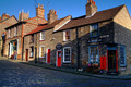 The beginning of Steep Hill in Lincoln. Steep Hill is, as the name implies, a hill which requires a certain level of fitness to ascend! Used as a defence method when the city of Lincoln was still a military town in the Roman and Norman times, the hill now attracts many of the visitors to Lincoln, not just to exert themselves on the way up, but to see the fashionable and fascinating shops that the area provides. Once at the top there is the castle, cathedral and the opportunity to have a breather before going back down!